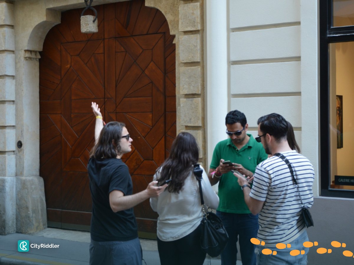 A team solves a riddle together in front of a carved wooden gate